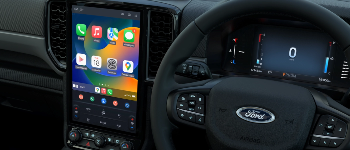 Ford Ranger factory touchscreen running Apple CarPlay alongside the digital instrument cluster and steering wheel controls